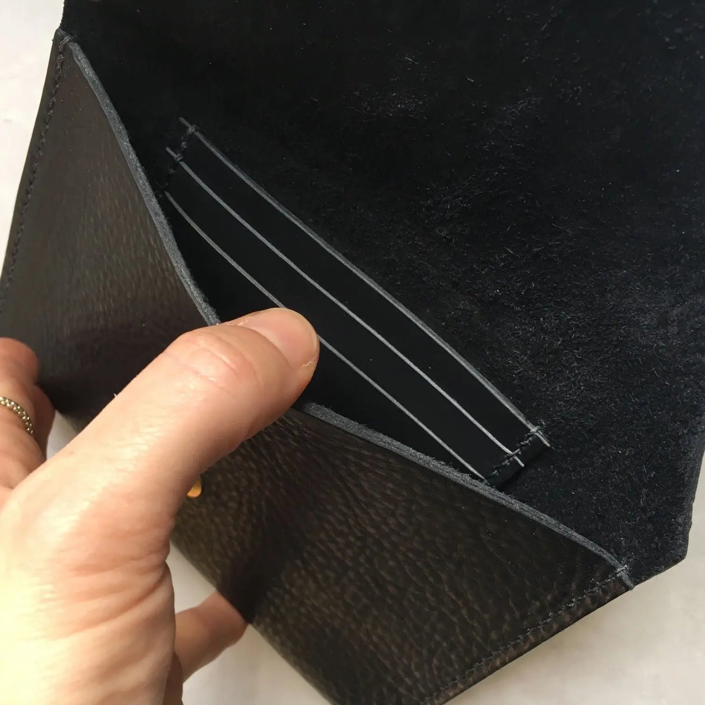 Black leather purse by CARV in minimalist design, inside view of card slots