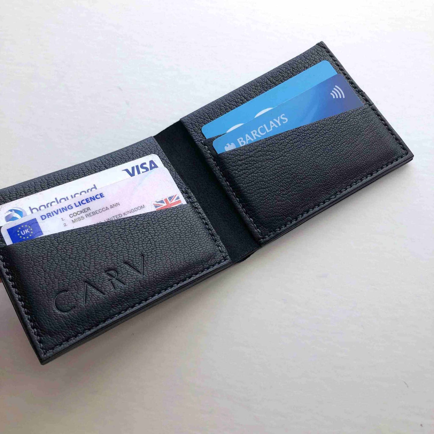 Handmade Black Leather Wallet with card slots open, showcasing premium craftsmanship.
