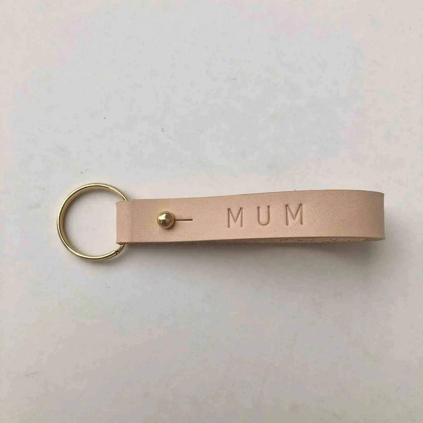 Nomad Personalised Leather Keyring in natural color with "MUM" embossed, featuring brass press stud closure.