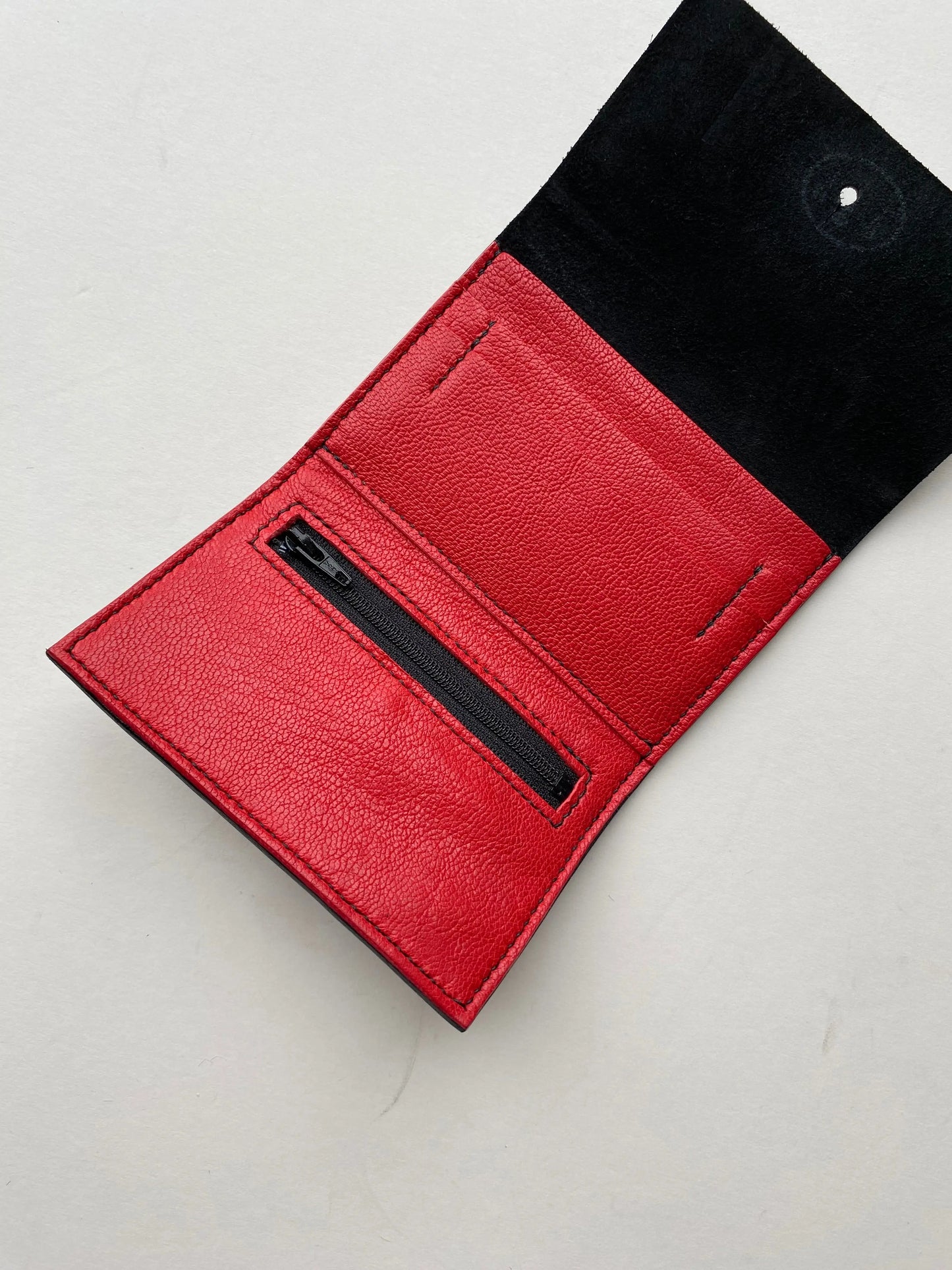 Inside the black leather women's wallet by CARV with red interior