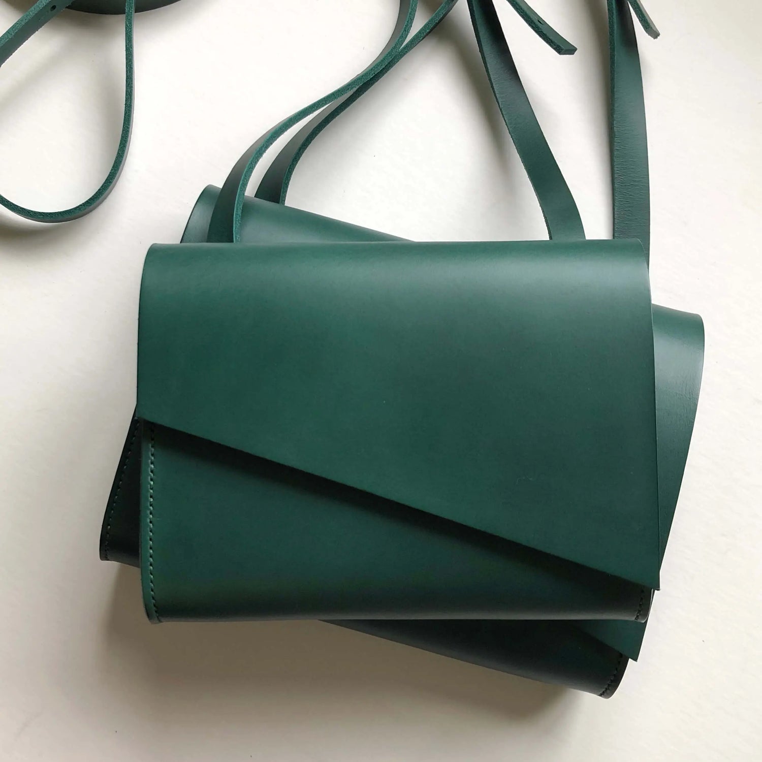 CARV green leather handbags stacked on top of eachother