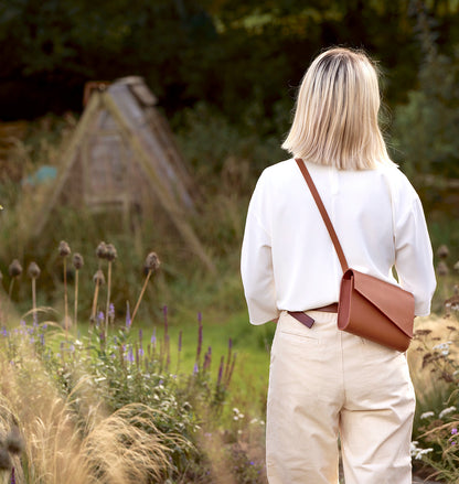 Handmade tan leather crossbody bag by CARV with minimalist flap 
