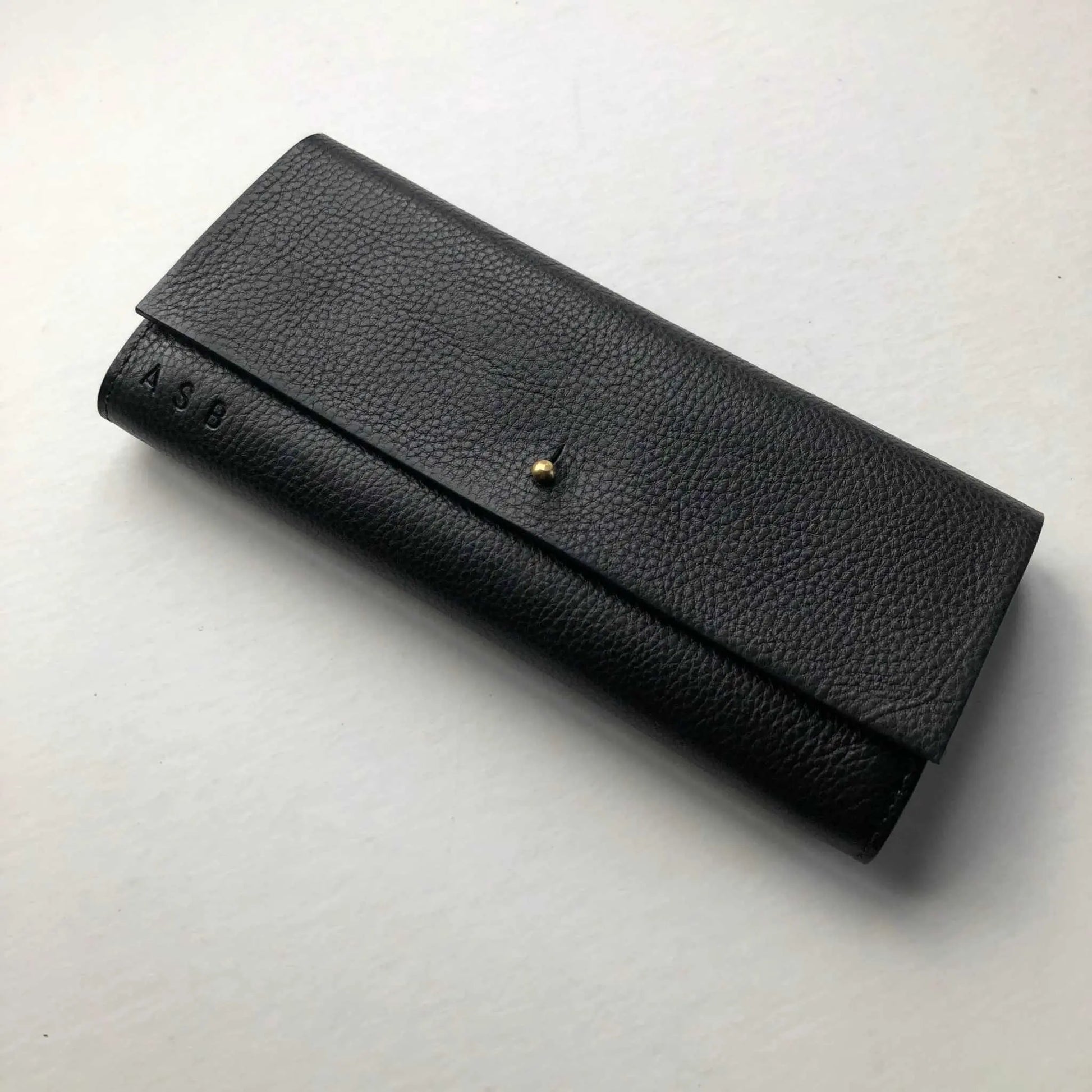 Nomad Maxi Black Leather Purse, featuring a solid brass press stud and personalization option.