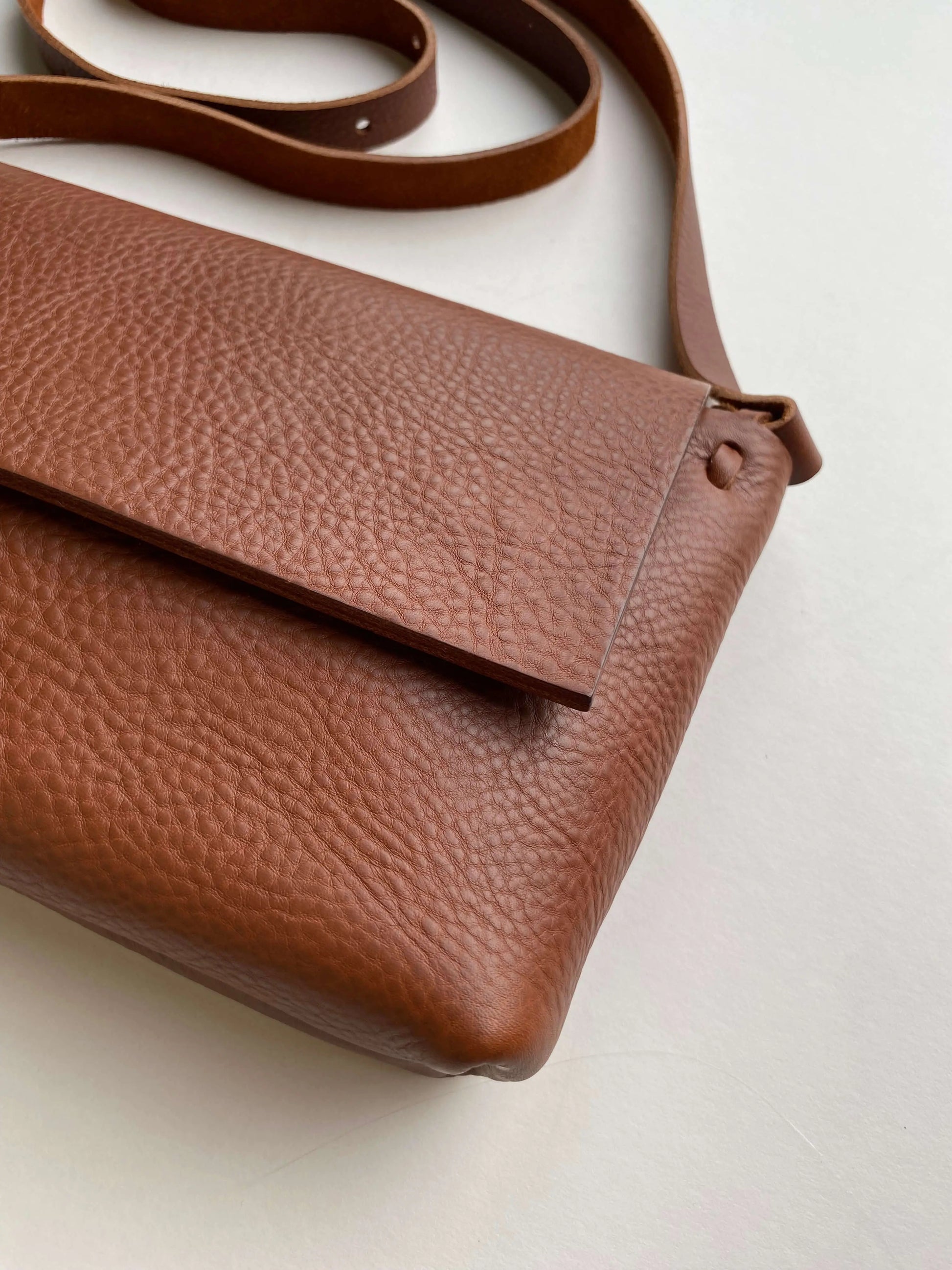 Tan leather bag by CARV in minimalist design and textured full grain leather