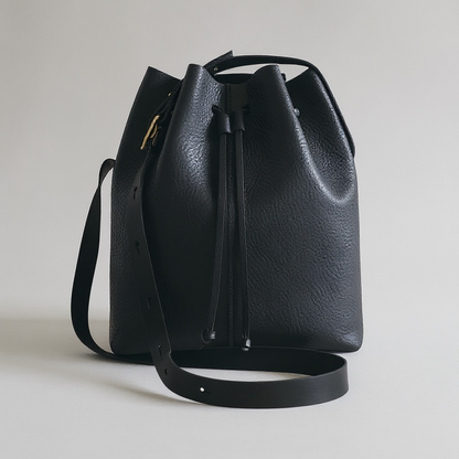 Black leather bucket bag on a light gray background